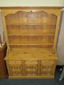 A LIGHT PINE KITCHEN DRESSER WITH THREE DRAWERS AND CUPBOARDS BELOW H-200 W-143 D-49 CM