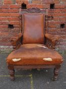 A LATE VICTORIAN CARVED OAK ARMCHAIR