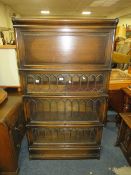 A VINTAGE OAK 'GLOBE WERNICKE' FOUR STAGE LEADED AND PANELLED BOOKCASE - WITH SLIM BOTTOM DRAWER H-