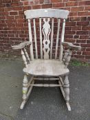 A LARGE STRIPPED WINDSOR ROCKING ARMCHAIR