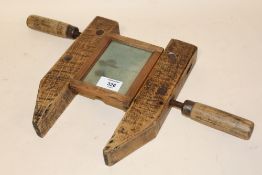 AN UNUSUAL WOODEN PICTURE FRAMING DEVICE