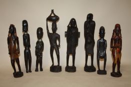 A COLLECTION OF EIGHT ASSORTED CARVED WOODEN TRIBAL STYLE FIGURES