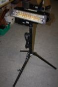 AN ELECTRIC HEAT LAMP ON TRIPOD BASE
