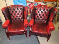 A PAIR OF OXBLOOD RED LEATHER WINGBACK ARMCHAIRS (2)