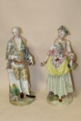 A PAIR OF MEISSEN STYLE FIGURES OF A YOUNG LADY AND A YOUNG MAN BOTH HOLDING A BASKET AND A POSY