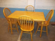 A MODERN DINING TABLE WITH FOUR CHAIRS