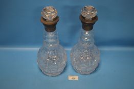 A PAIR OF HALLMARKED SILVER COLLARED DECANTERS