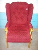 A RED FABRIC FIRESIDE CHAIR