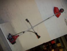 A LARGE HEAVY DUTY PETROL STRIMMER