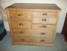 AN ANTIQUE PITCHED PINE SEVEN DRAWER CHEST OF DRAWERS