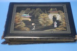 AN ORIENTAL STYLE POSTCARD / PHOTOGRAPH ALBUM