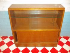 A TEAK GLAZED RETRO G-PLAN E GOMME BRANDOM BOOKCASE WITH SLIDING DOORS