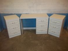 A MODERN DRESSING TABLE AND TWO NARROW THREE DRAWER BEDSIDE CHESTS