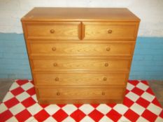 A TEAK TWO OVER FOUR CHEST OF DRAWERS