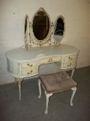A LOUIS STYLE KIDNEY SHAPED ORNATE TRIPLE MIRRORED DRESSING TABLE AND STOOL