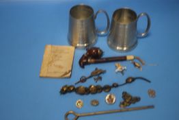 TWO WHITE METAL TANKARDS AND A COLLECTION OF MILITARY TYPE BUTTONS AND BADGES ETC.