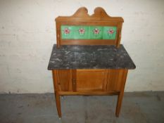 AN ANTIQUE MARBLE TOPPED WASH STAND WITH TILED BACK