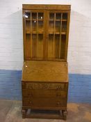AN ANTIQUE OAK, LEATHER INLAID BUREAU BOOKCASE