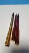 A PARKER 88 MAROON & GOLD FOUNTAIN PEN, gold plated (1988) together with two Parker Imperial Line (