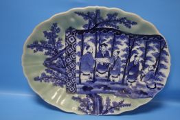 A JAPANESE TURN OF THE CENTURY LARGE OVAL PLATE, HAND PAINTED, BLUE ON CELADON BACKGROUND, 43 x 33