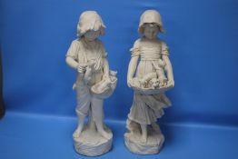A PAIR OF PLASTER FIGURINES, GIRL WITH PUPPIES AND GIRL WITH KITTENS