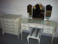 A LOUIS STYLE KIDNEY SHAPED DRESSING TABLE AND A FIVE DRAWER CHEST