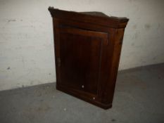 AN ANTIQUE WALL HANGING OAK CORNER CABINET