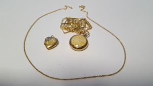 A 9 CT GOLD LOCKET ON CHAIN TOGETHER WITH A YELLOW METAL FOB WATCH ON CHAIN