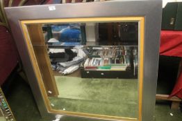 A MODERN FRAMED MIRROR 99 X 94 CM