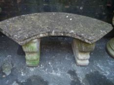 A HEAVY RECONSTITUTED STONE CRESCENT SHAPED TWIN PEDESTAL SEAT
