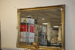 A LARGE GILT FRAMED MIRROR, 130 X 102 CM