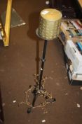 A TRIPOD CAST IRON CANDLE STAND WITH CANDLE
