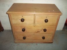 AN ANTIQUE PINE TWO OVER TWO, FOUR DRAWER CHEST OF DRAWERS