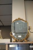 A SHIELD SHAPED DRESSING TABLE MIRROR