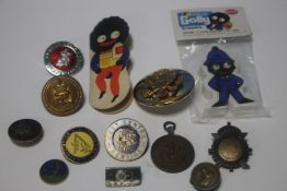 A GOLDEN SHRED GOLLY NEEDLE CASE, A GOLLY POLICEMAN ERASER AND A QUANTITY OF ASSORTED BADGES