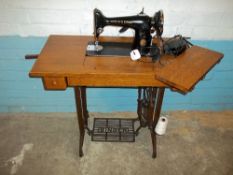 AN ANTIQUE SINGER TREADLE SEWING MACHINE