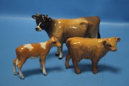 A BESWICK JERSEY COW, A BESWICK GUERNSEY CALF AND A BESWICK HIGHLAND CALF (3)