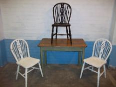 A SCRUB TOP TABLE WITH THREE WHEELBACK MATCHED CHAIRS