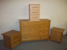 FOUR CHESTS OF DRAWERS COMPRISING AN EIGHT DRAW SIDE BY SIDE OAK STYLE, TWO TWO DRAWER CHESTS AND