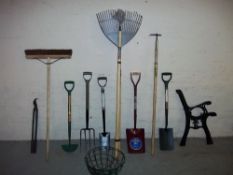 A QUANTITY OF MOSTLY NEW GARDEN TOOLS AND A PAIR OF CAST BENCH ENDS