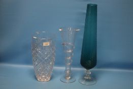 A HEAVY CUT GLASS VASE, A TALL TWISTED STEM VASE AND A TALL BLUE GLASS VASE (3)