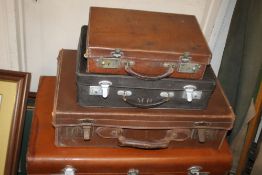 FOUR LEATHER TYPE SUITCASES
