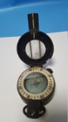 A CASED MILITARY TYPE COMPASS