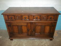 AN OAK ANTIQUE SIDEBOARD WITH CARVINGS