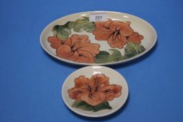 A MOORCROFT 'HIBISCUS' OVAL DISH TOGETHER WITH A MATCHING PIN DISH
