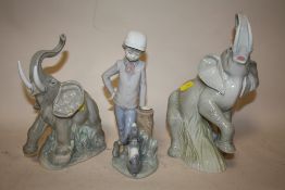 A NAO ELEPHANT FIGURE TOGETHER WITH ANOTHER AND A NAO FIGURE OF A BOY LEANING AGAINST A STUMP