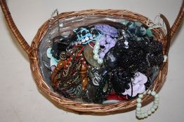 A BASKET OF COSTUME JEWELLERY