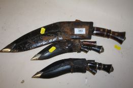 A SELECTION OF INDIAN KUKRI KNIVES WITH SCABBARDS