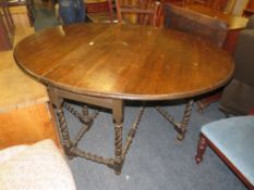 A LARGE OAK BARLEYTWIST GATELEG DINING TABLE H-79 CM W-162 CM