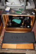 A VINTAGE CASED SINGER SEWING MACHINE MODEL NUMBER EK595205